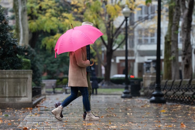 Pedestrians walk in the rain through Rittenhouse Square late last month. After a bone-dry September and October, the rains have returned.