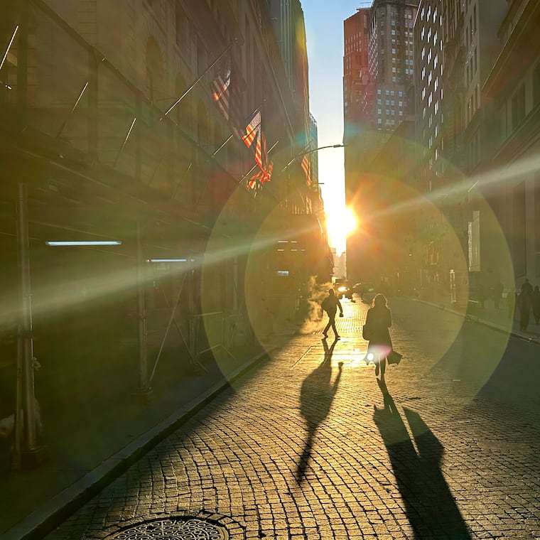 People walk on Wall Street in New York's Financial District on Wednesday, Dec. 18, 2024.