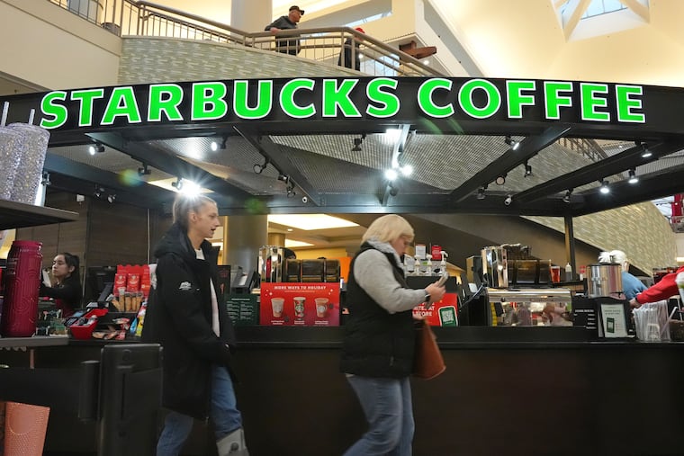 Shoppers pass a Starbucks kiosk at the Walden Galleria in Buffalo in November.