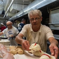 Joseph Fulton, a boiler cook and 30-year employee, preps crab imperial for the dinner rush at the Lobster House, which is celebrating its 100th year in 2022.