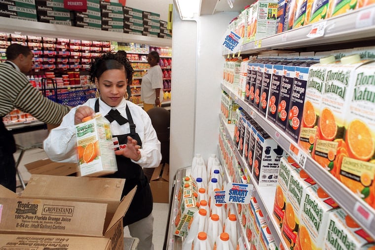 Rosa Padilla stocking the shelves at the new Pathmark in North Philadelphia in 1999.