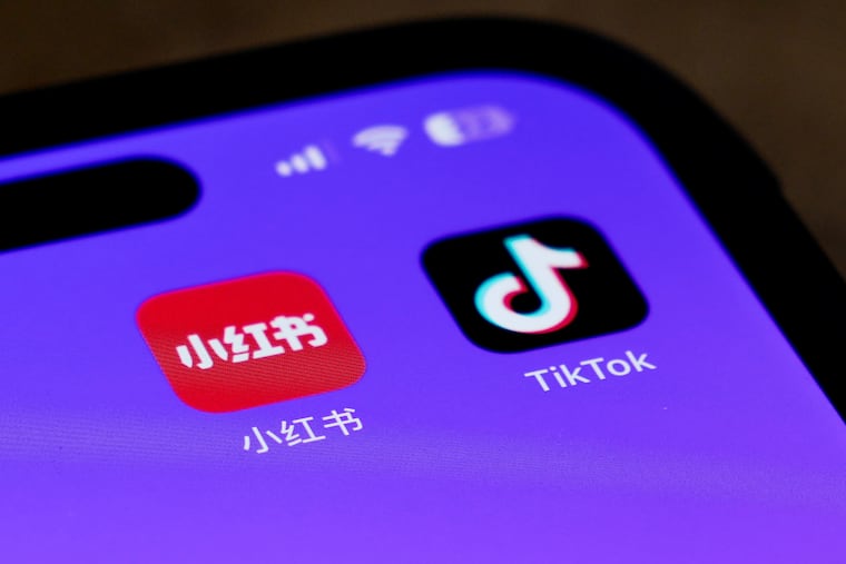 Icons for the smartphone apps Xiaohongshu and TikTok are seen on a smartphone screen in Beijing on Tuesday.