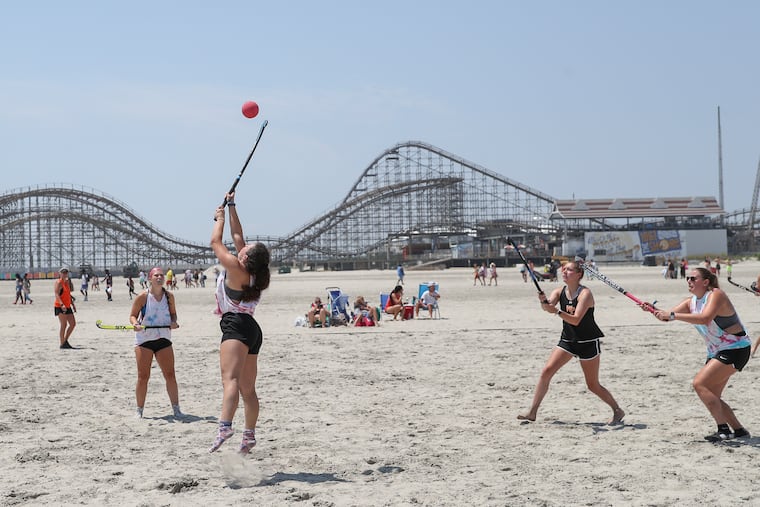 Cinnaminson and William Paterson compete in the Sticks in the Sand Beach Hockey Tournament on the beach in Wildwood on July 23, 2022. Teams from New Jersey, Pennsylvania, and along the East Coast competed in the tournament, the type of event Wildwood says is dependent on its wide beaches and which have become the economic engine of the beach town.