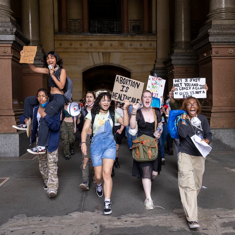 High schoolers from Philadelphia walk through the north portal of Philadelphia's City Hall to meet up with other students to protest for abortion rights on May 25, 2022.