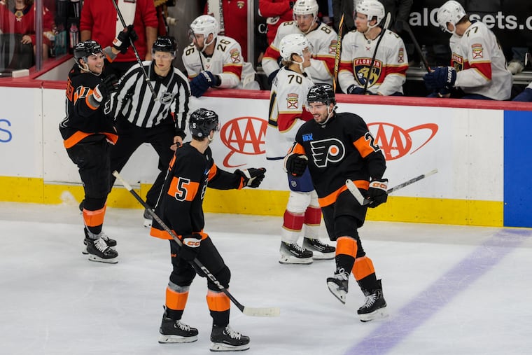 Flyers' Noah Cates (right) celebrates with his teammates after his go ahead goal against the Panthers.