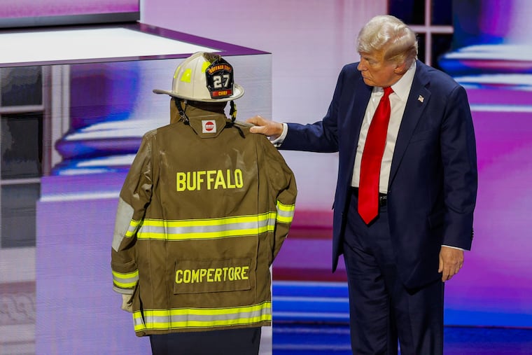 President-elect Donald Trump with the firefighter helmet and jacket that belonged to Corey Comperatore, during his address to the Republican National Convention in July.