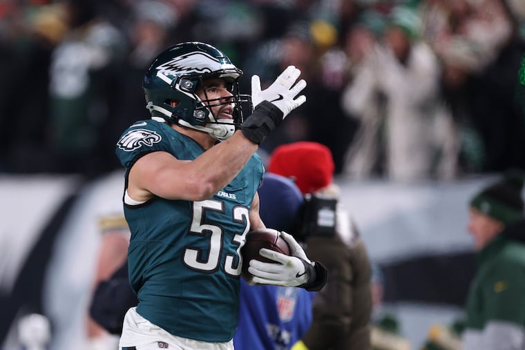 Eagles linebacker Zack Baun blows kisses to the crowd after he intercepted a Jordan Love pass late in the second quarter. 