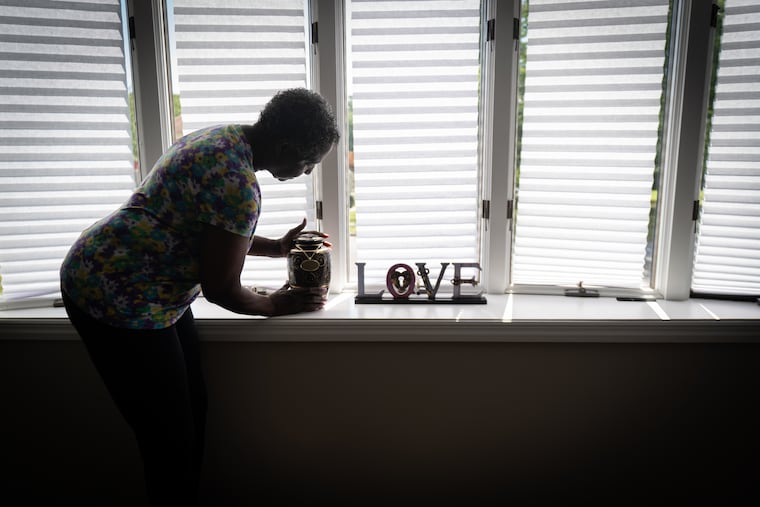 Hazel Rollerson, mother of Elwood Porter, who died of an overdose in the summer of 2021, shown here with the ashes of her son, in her home in Sicklerville, New Jersey, Tuesday, August 16, 2022.