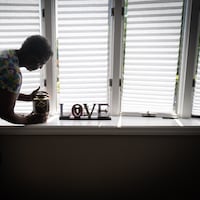 Hazel Rollerson, mother of Elwood Porter, who died of an overdose in the summer of 2021, shown here with the ashes of her son, in her home in Sicklerville, New Jersey, Tuesday, August 16, 2022.