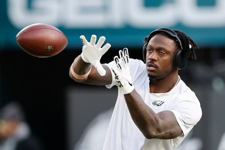 Eagles wide receiver A.J. Brown warming up before he made a stir on the sideline Sunday in the playoff game against the Packers. 