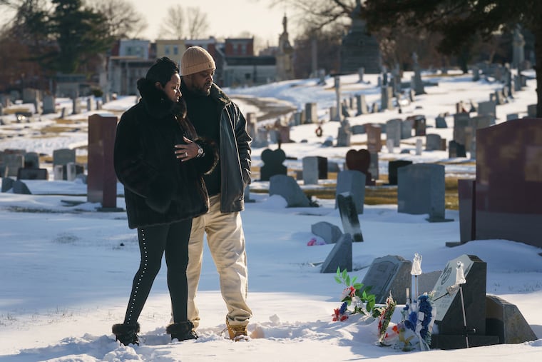 (Left to Right) Cindy and Bryant Heard, at the grave of their son Bryant Heard II, at Northwood Cemetary, in Philadelphia, Monday, January 31, 2022. Their son was fatally shot near their home in Olney last year.