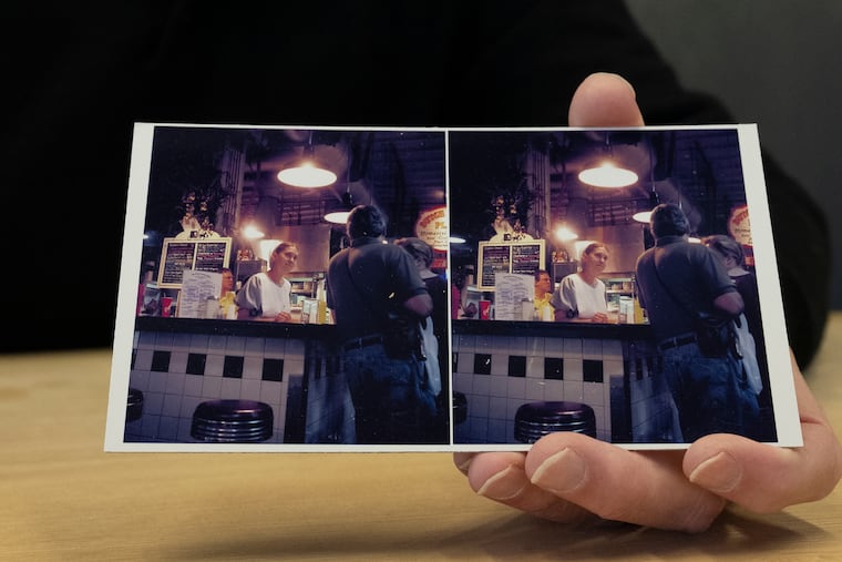 David O'Neil, former manager of Reading Terminal Market, shows an old photo taken by Laszlo of the market.