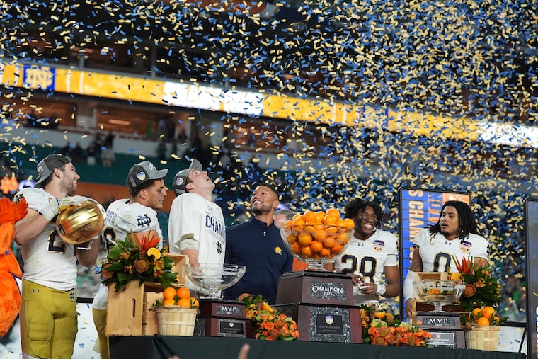 Notre Dame head coach Marcus Freeman, center, and members of the team celebrate after winning the Orange Bowl College Football Playoff semifinal game against Penn State on Thursday.