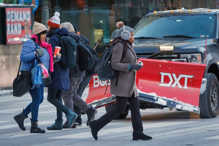 Center City pedestrians bundled up for the winds and cold on Tuesday. They can expect repeats the next two days.