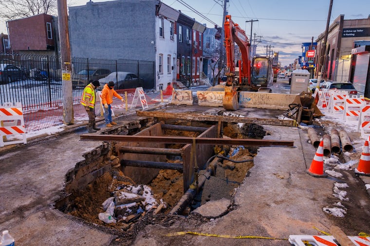 Crews work to repair a sinkhole on North Sixth Street near Rising Sun Avenue on Wednesday.