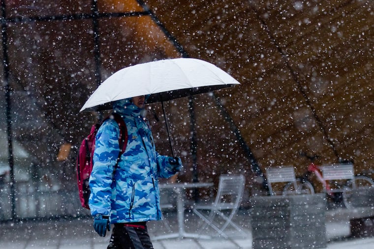 A pedestrian crosses the Temple University campus in the snow on Jan. 3.