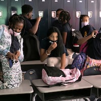 Seventh grade students Phoenix McGhee, Alyssa Vega, and Shakayla Johnson pack up their bags after social studies class on the first day of school at William H. Ziegler Elementary School on Tuesday, Aug. 31, 2021.