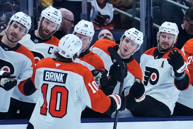 Flyers right wing Bobby Brink (left) is congratulated by his teammates after scoring in the first period.