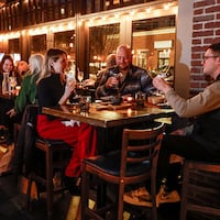 Jesse Andreozzi (center), known as Philly's "Mr. Zero Proof" and a zero-proof menu consultant, talks with friends at Bar Hygge on Fairmount Street.