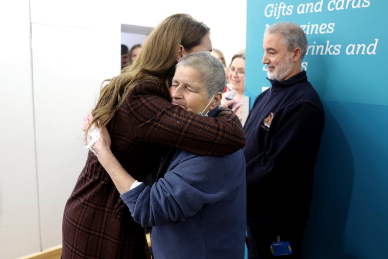 Britain's Princess Kate, left, hugs Rebecca Mendelhson during a visit on Tuesday to The Royal Marsden Hospital, where she received her cancer treatment, in London, England.