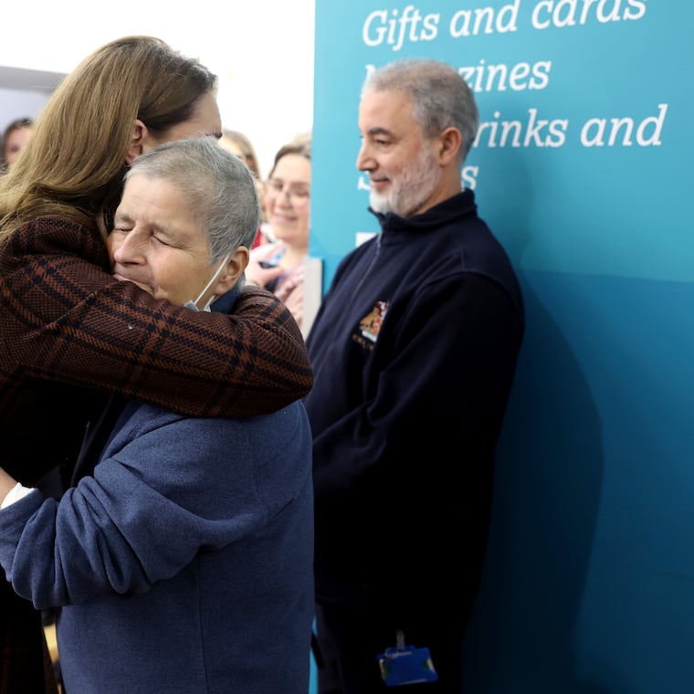 Britain's Princess Kate, left, hugs Rebecca Mendelhson during a visit on Tuesday to The Royal Marsden Hospital, where she received her cancer treatment, in London, England.