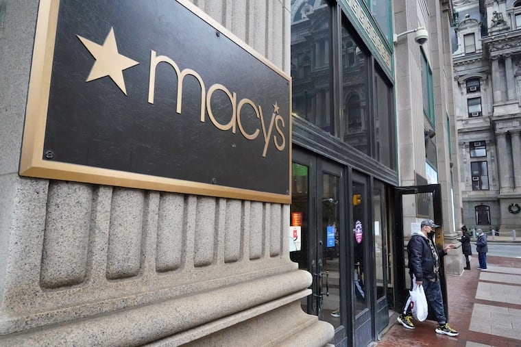 A shopper leaves Macy’s in Center City, Philadelphia, Pa., December 11, 2021.