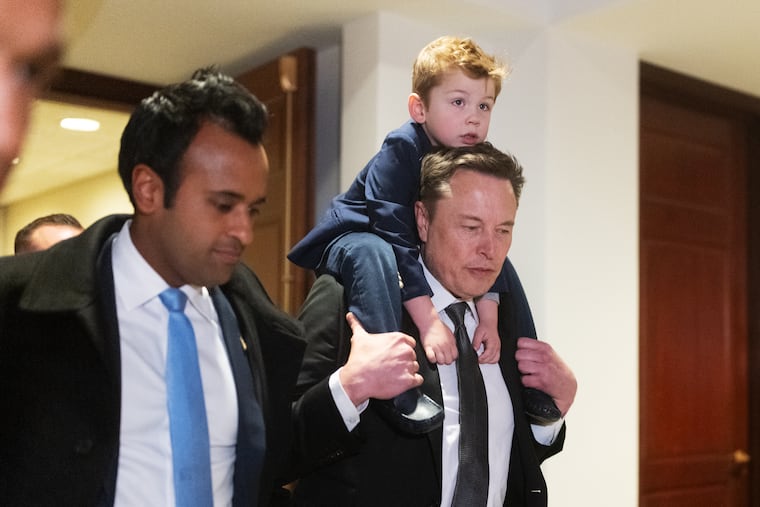 Vivek Ramaswamy and Elon Musk, with his son X, at the U.S. Capitol building on Dec. 5 in Washington. Musk and Ramaswamy have proposed cutting government spending by 30%.