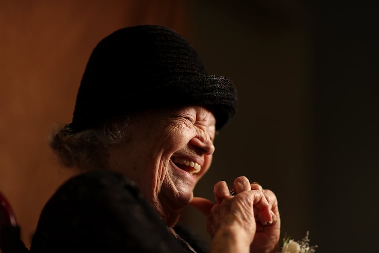 Juanita Goss, 101, laughs during a portrait session at the Montgomery County Centenarian Celebration in Lansdale on May 14, 2024.