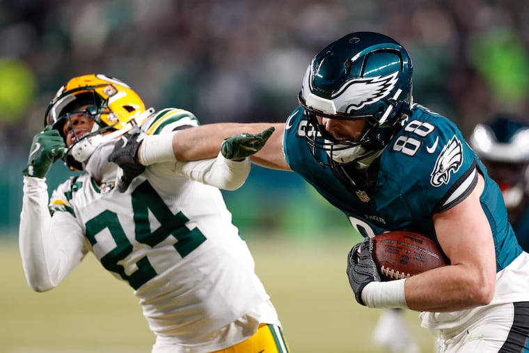 Eagles tight end Dallas Goedert pushes past Packers cornerback Carrington Valentine on his way into the end zone to score during the third quarter.