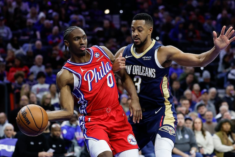 Sixers guard Tyrese Maxey gets held passing the basketball against Pelicans guard CJ McCollum during the third quarter.