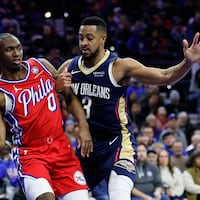 Sixers guard Tyrese Maxey gets held passing the basketball against Pelicans guard CJ McCollum during the third quarter.